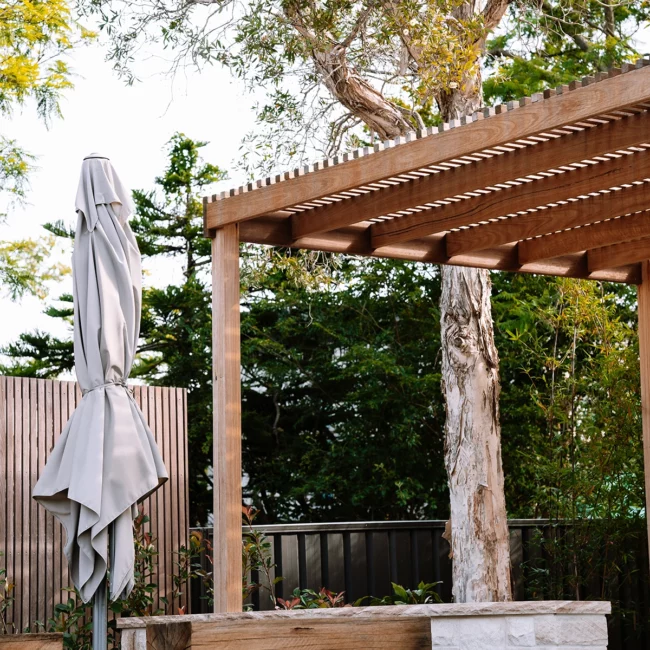 timber pergola and outdoor umbrella and firepit